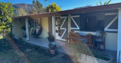 En vente une maison de type bourbon bois sur un terrain de 409m2 au 2ème village de la Plaine des Palmistes